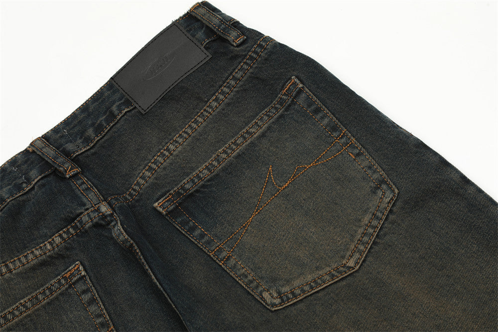 Close-up of dark blue jeans with a visible brand label on a white background