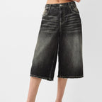 Black denim shorts on a white background