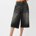 Black denim shorts on a white background