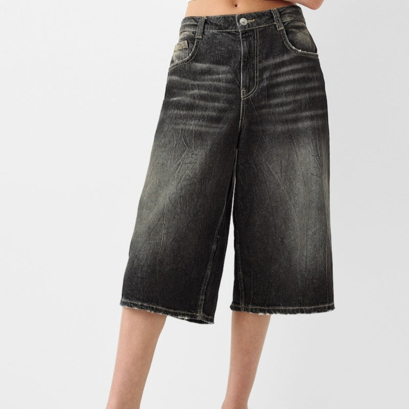Black denim shorts on a white background