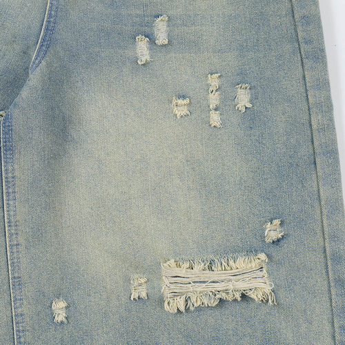 Close-up of a distressed denim jacket with frayed edges.