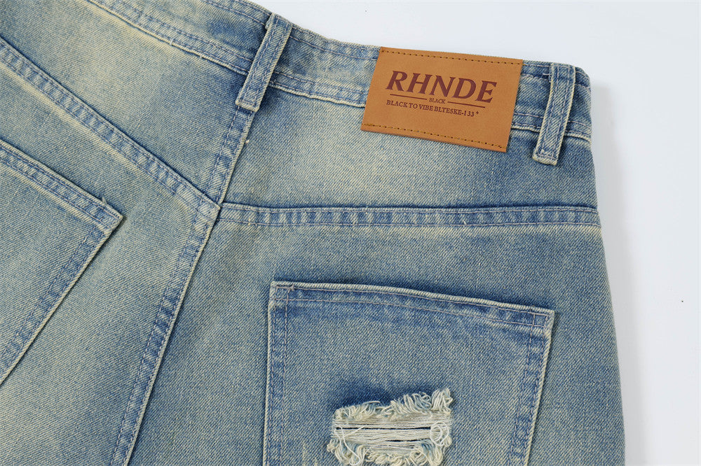 Close-up of blue denim jeans with a brand label on a white background
