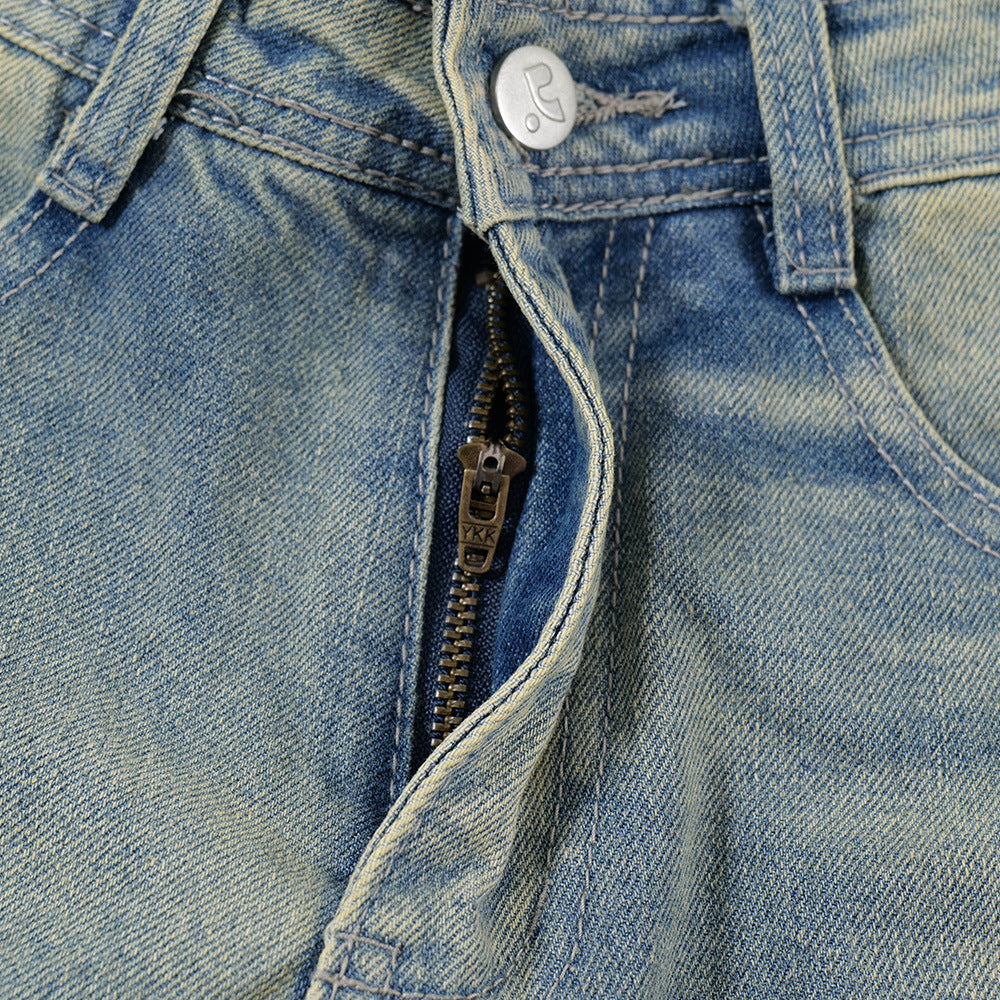 Close-up of a blue denim jacket with a zipper and button detail.