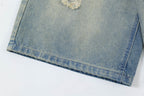 Close-up of a folded blue denim fabric on a white background