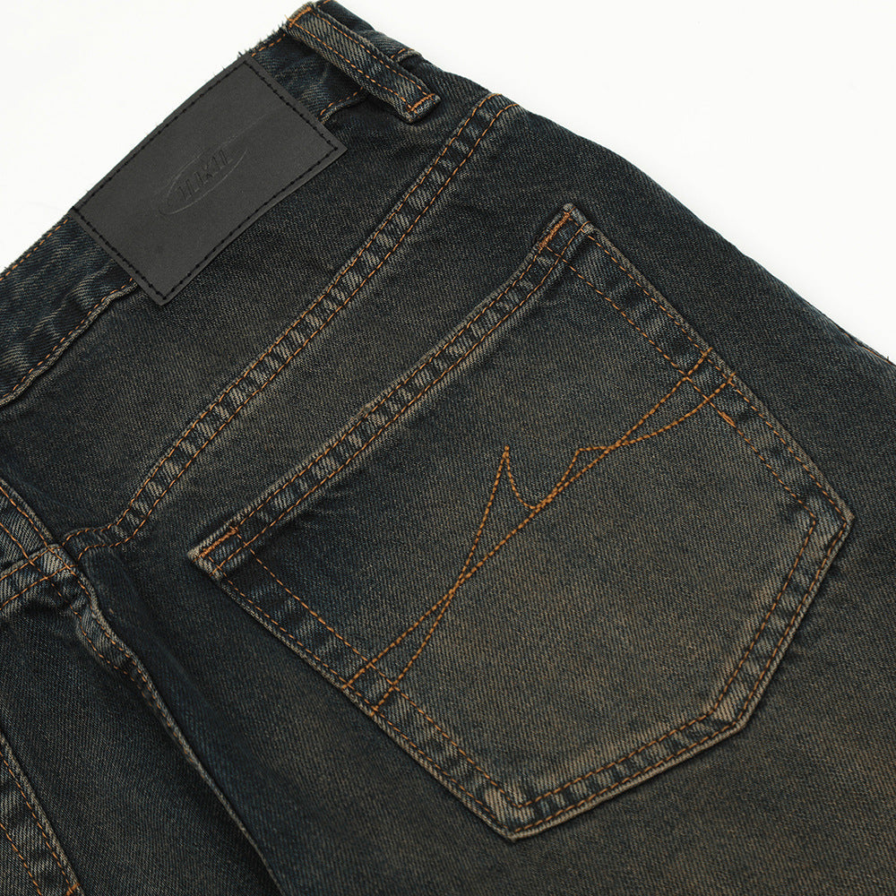 Close-up of dark blue jeans with a brand label on a white background