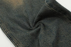 Close-up of dark denim fabric with visible texture and color variations.