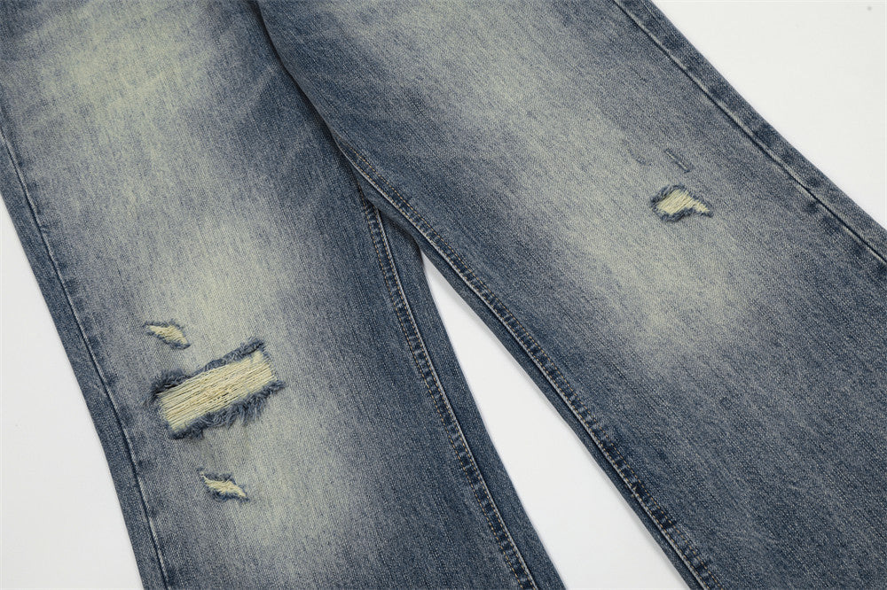 Distressed gray jeans on a white background