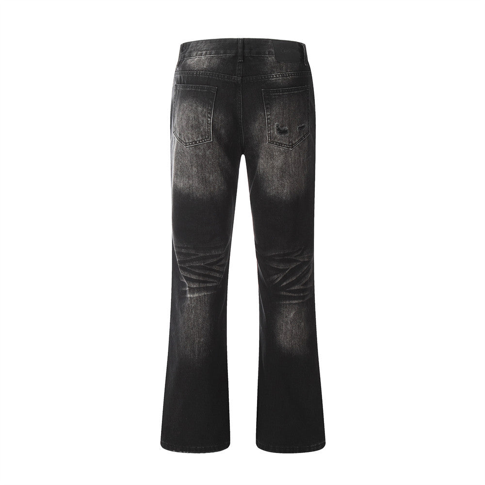 Black distressed jeans on a white background
