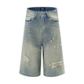 Distressed denim shorts on a white background